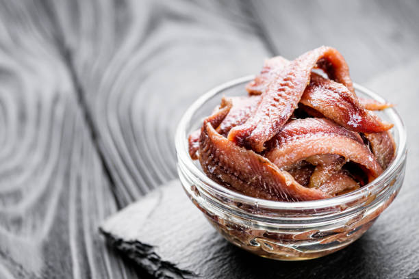 istock canned anchovy fillet on a black wooden rustic background 1392551103