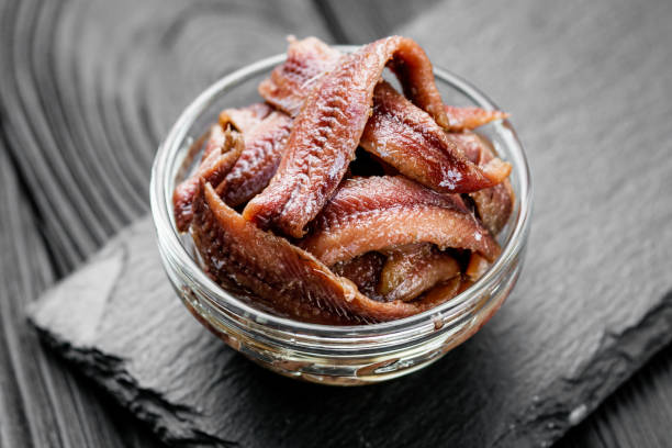 istock canned anchovy fillet on a black wooden rustic background 1392551133