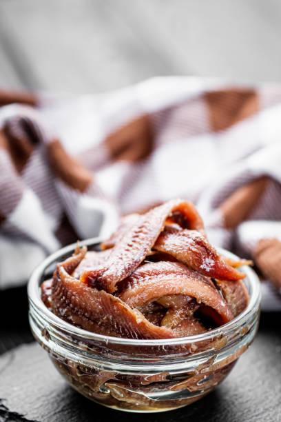 istock canned anchovy fillet on a black wooden rustic background 1392551201