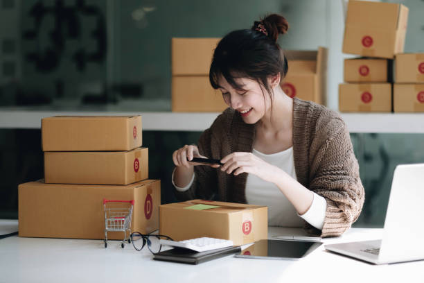 istock Startup small business SME, Entrepreneur owner using smartphone or tablet taking receive and checking online purchase shopping order to preparing pack product box. Selling online ideas concept 1392551242