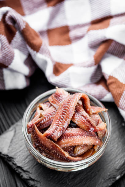 istock canned anchovy fillet on a black wooden rustic background 1392551255