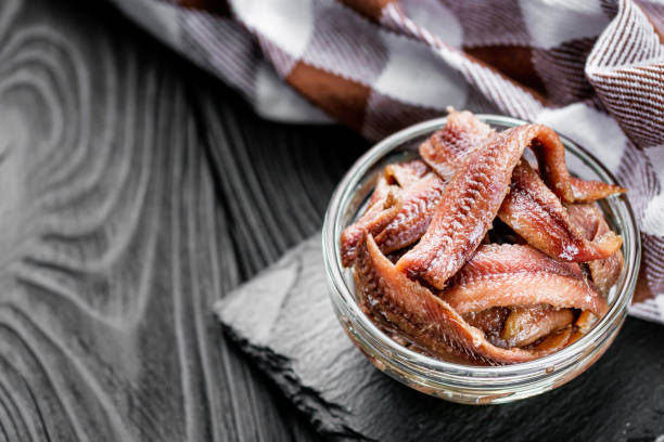istock canned anchovy fillet on a black wooden rustic background 1392551291
