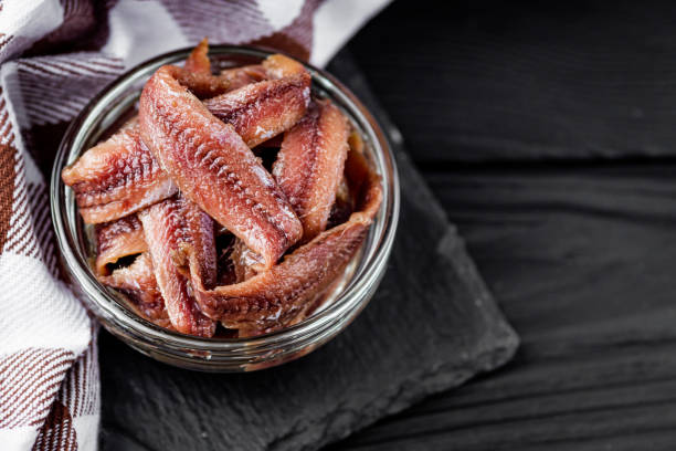 istock canned anchovy fillet on a black wooden rustic background 1392551310