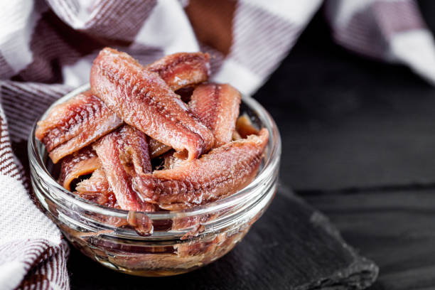 istock canned anchovy fillet on a black wooden rustic background 1392551343