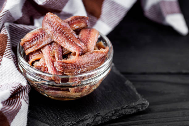 istock canned anchovy fillet on a black wooden rustic background 1392551349