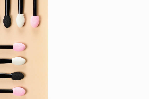 Set of applicants for shadows on yellow white background. Shadows and eye makeup. Application of eyebrows.