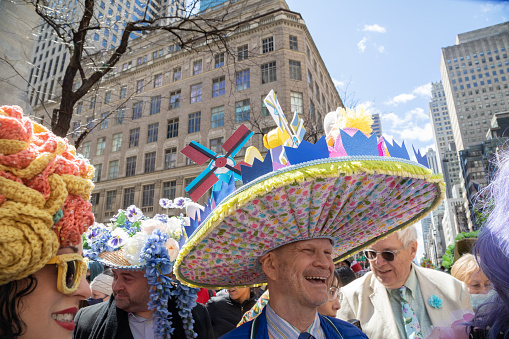 New York City, NY-April 17, 2022: A man with a Holland themed hat, smiles for the crowd, as he walks down Fifth Avenue during the annual Easter Bonnet Parade.