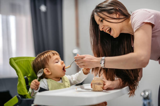istock Young Mother Feeding A One Year Old Boy 1392553197