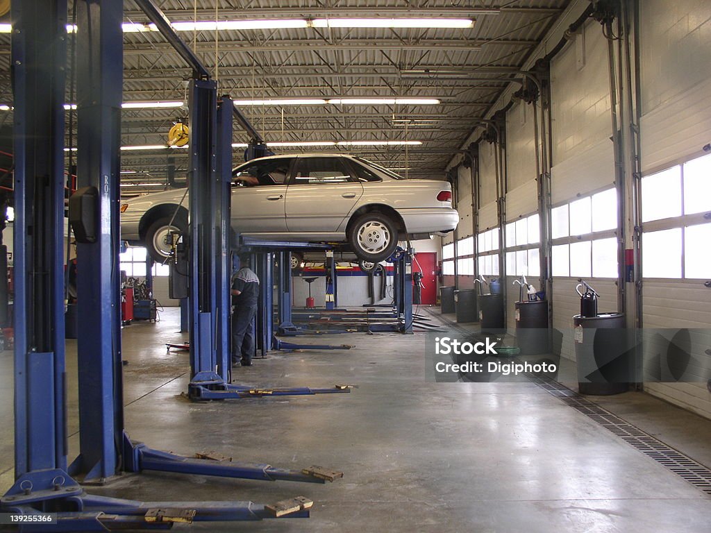 Auto service shop, wide view Auto service shops, repair for our machines. Illustrate: service, preventive maintenance, tires, oil, lube, repair, fixing things, taking care of things, expense, etc. Car Stock Photo