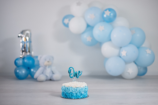 Light blue and white birthday setup for a one year old boy's birthday party.