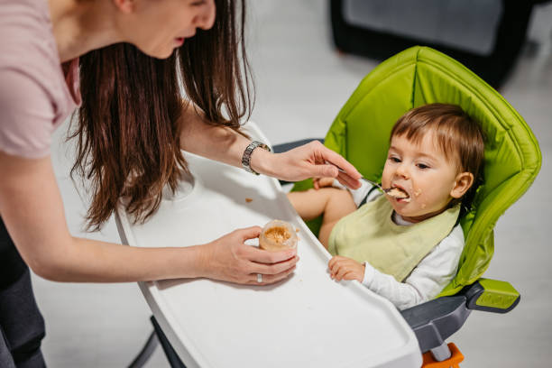 istock Young Mother Feeding A One Year Old Boy 1392553845