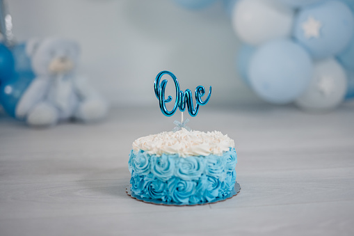 Light blue and white birthday cake for a one year old boy's birthday party.