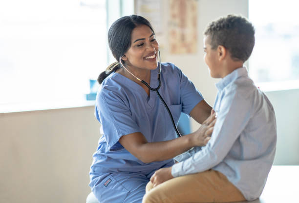 istock Nurse Listening to a Boys Heart 1392555764