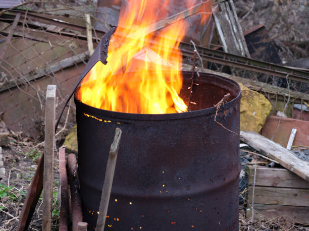 istock Fire burning inside an old rusty barrel outdoors 1392556214