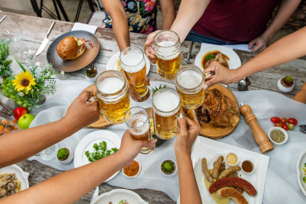 Friends Happiness Party Buffet Food Table Concept. Raise your glasses for a toast.