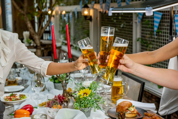 Friends Happiness Party Buffet Food Table Concept. Raise your glasses for a toast.