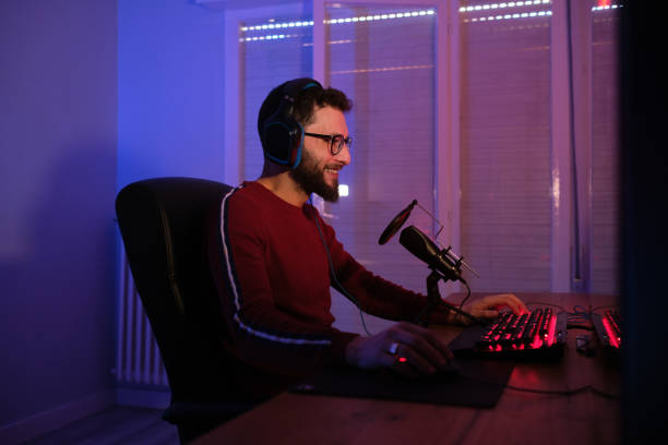istock Happy young gamer playing from his computer 1392558482