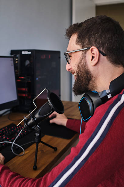 istock Young man doing podcast inside his house 1392558753