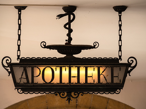 Historical illuminated pharmacy board with the German inscription Apotheke - translation: pharmacy