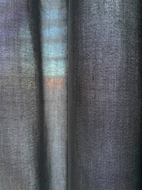 istock Dark gray fabric with small holes as texture or background. 1392561059