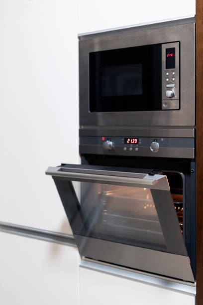 istock Stylish built-in oven and microwave in kitchen 1392562817