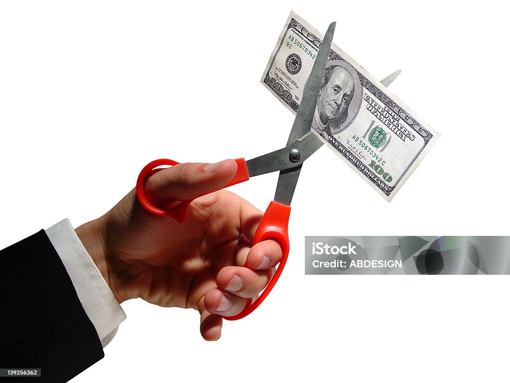 price cut business man cutting a $100 dollar bill, isolated on white. Cut Out Stock Photo