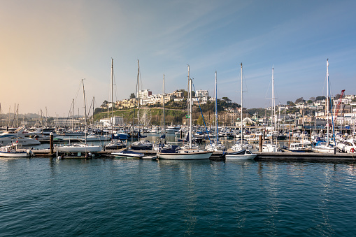 Sun over Torquay Harbour with boats in the marina