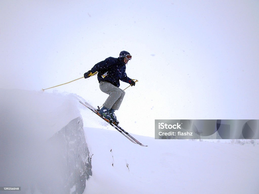 Cliff jump A skier jumping from a cliff. Alpine Skiing Stock Photo