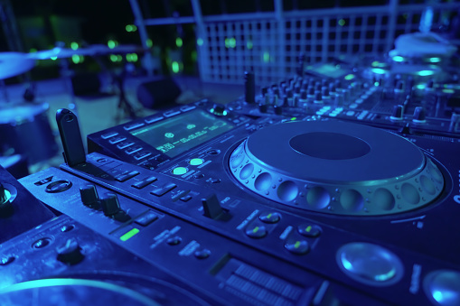 DJ console desk at nightclub.