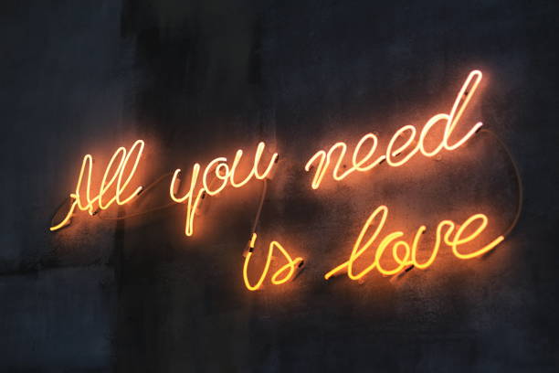 istock Lighting words all you need is love on the wall 1392567901