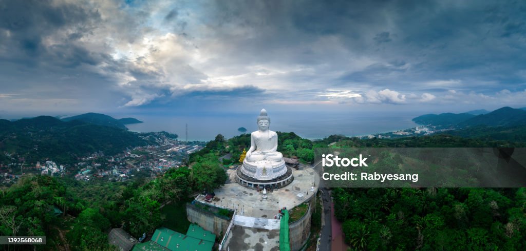 Aerial view during sunset of Phuket Big Buddha, or The Great Buddha of Phuket, is a seated Maravija Buddha statue in Phuket, Thailand. Giant Buddha Stock Photo