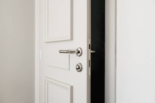 White bathroom door slightly open or left ajar