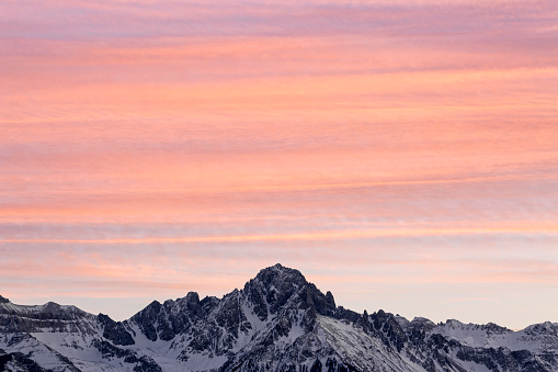 Sunset brings pastel stripes over the southern sky above Mount Sneffels of the San Juan Mountains in Colorado.