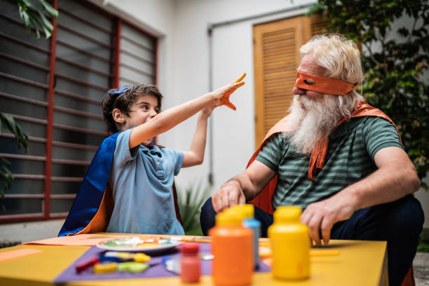 istock Boy showing hands with paint to grandfather 1392571469