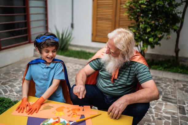 istock Boy and grandfather playing with paint 1392571698