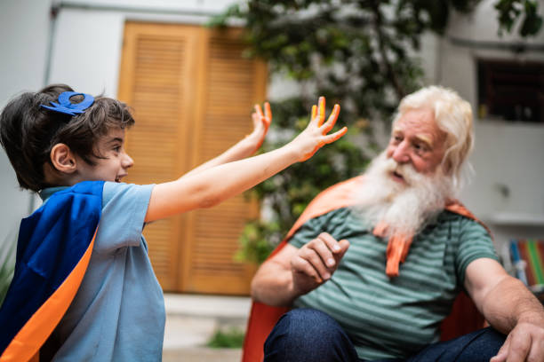Boy showing hands with paint to grandfather