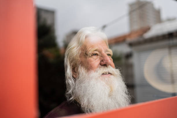 istock Senior man looking away contemplating at home 1392571773