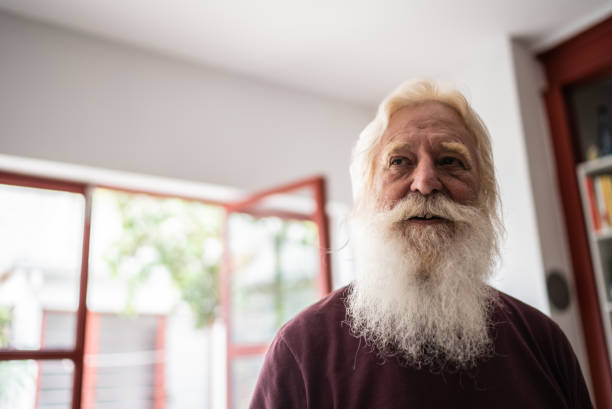 Senior man looking away contemplating at home