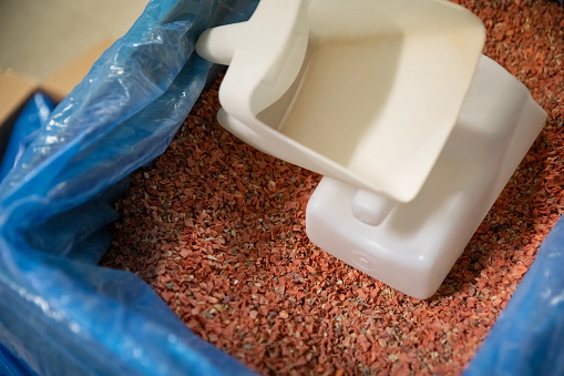 Close up of dried flakes in bulk bin with scoop