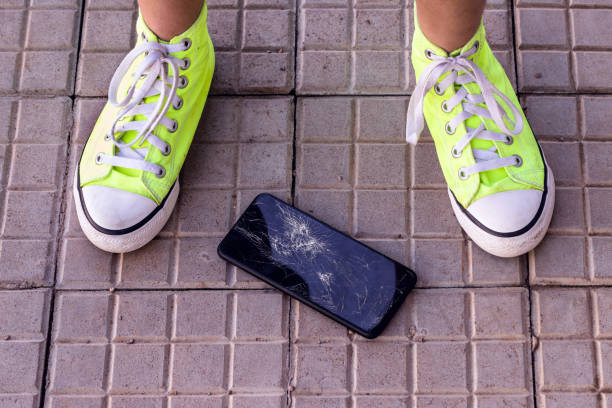 istock smartphone device dropped on floor with broken screen, top view, cellphone accident 1392574200