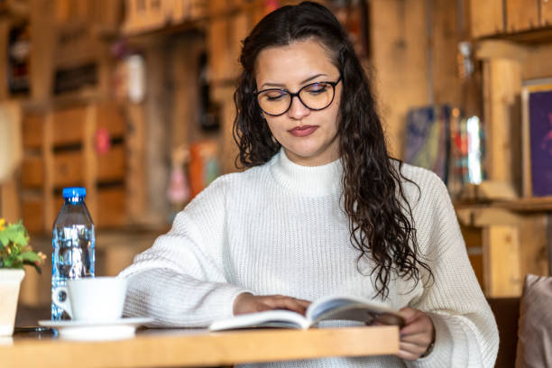istock While I drink my coffee in the cafe, I will read from the book. 1392574475