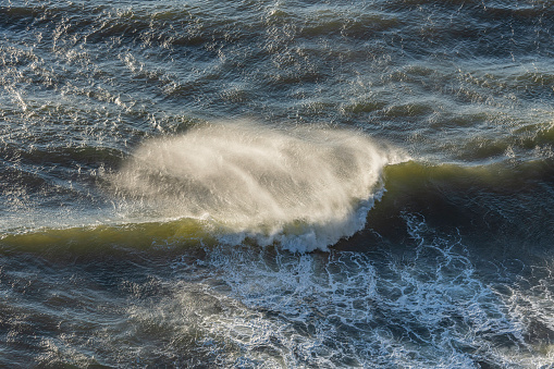 Breaking Pacific Ocean waves on the Oregon Coast near Heceta Head Lighthouse.