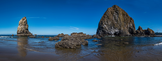 Cannon Beach is recognized by the well-known landmark Haystack Rock, located southwest of downtown Cannon Beach. Near Haystack Rock are the Needles, two tall rocks rising straight out of the water. Cannon Beach, Oregon. Pacific Ocean. Tolovana Beach State Recreation Site.