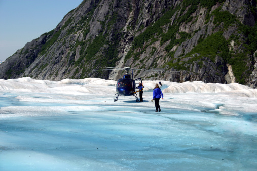 A helicopter about to take off from a glacier.