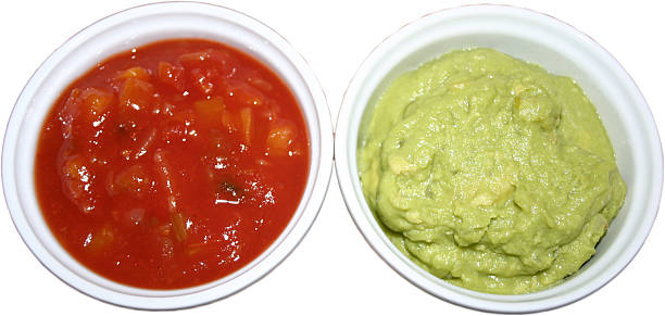 A bowl of salsa and guacamole stock photo