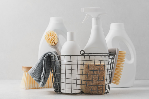 Set of detergents In basket. Cleaning agent, rag, sponge, brushes
