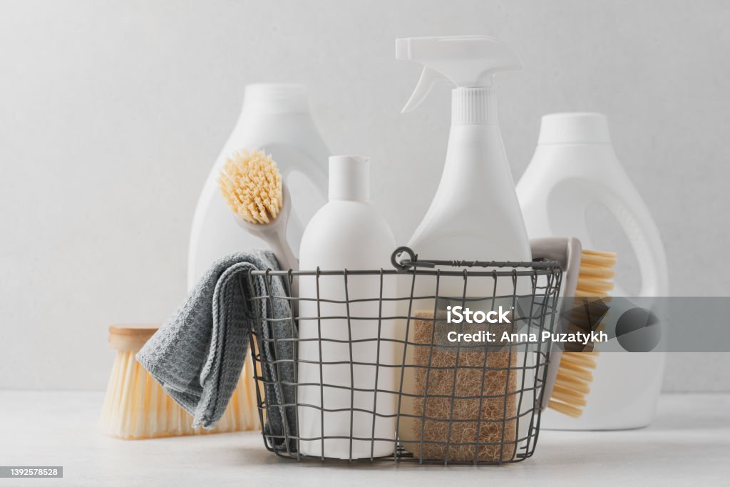 Cleaning service concept Set of detergents In basket. Cleaning agent, rag, sponge, brushes Merchandise Stock Photo