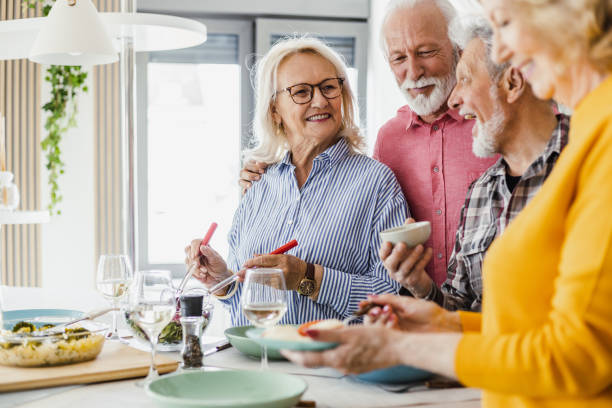 istock Cheerful seniors having lunch at home 1392578608