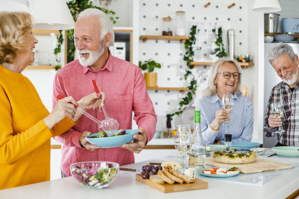 istock Cheerful seniors having lunch at home 1392578611
