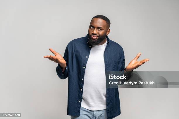Africanamerican Guy Shrugging Shoulders Asking What Is The Problem Stock Photo - Download Image Now